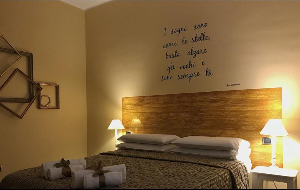 a bedroom with a bed with words on the wall at Le Camerette di Edda in Cassino