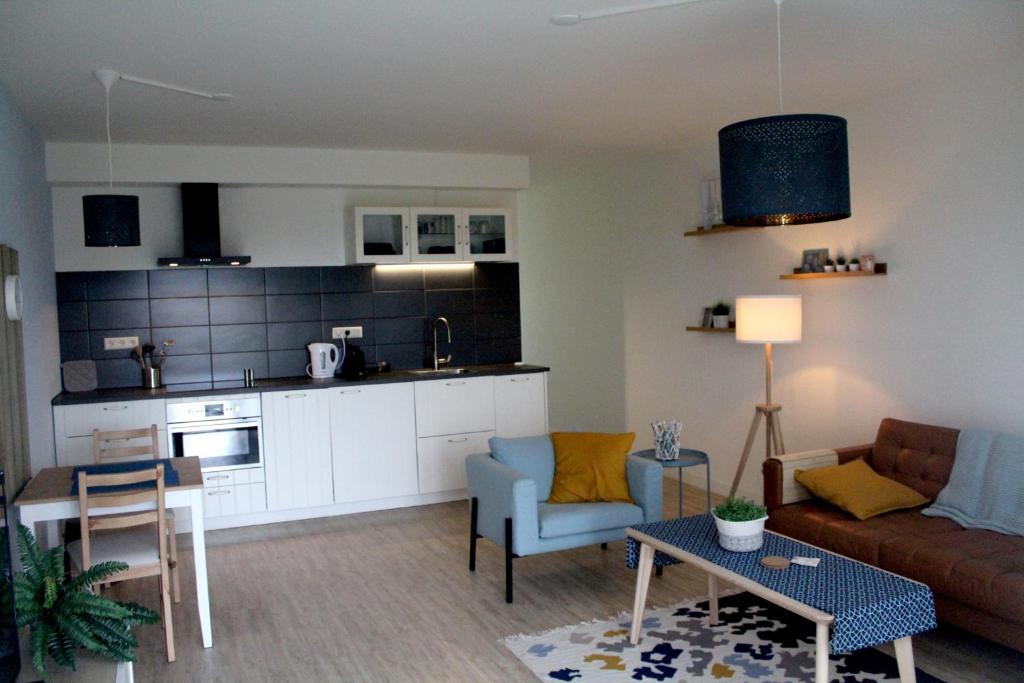 a living room with a couch and a table at Landzicht in Woubrugge