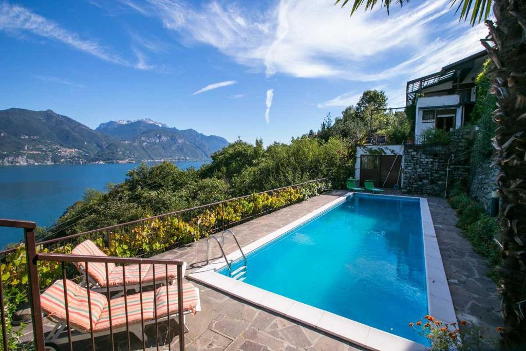 a swimming pool with a view of the water at Villa la Grona in Menaggio