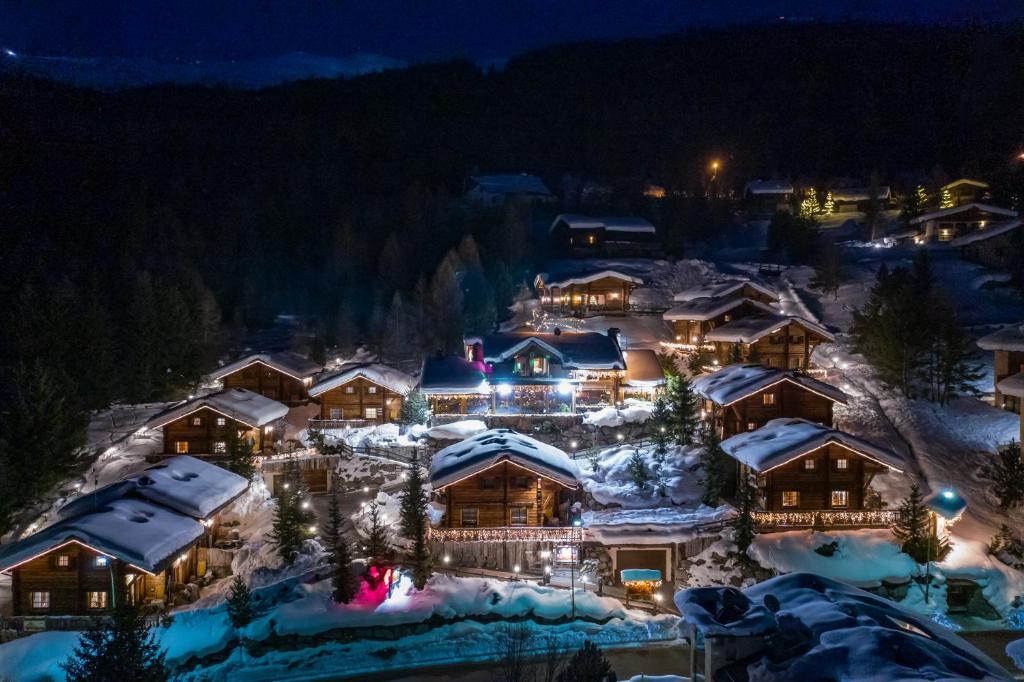 a resort with a lot of trees and a lot of skis at Park Chalet Village in Livigno