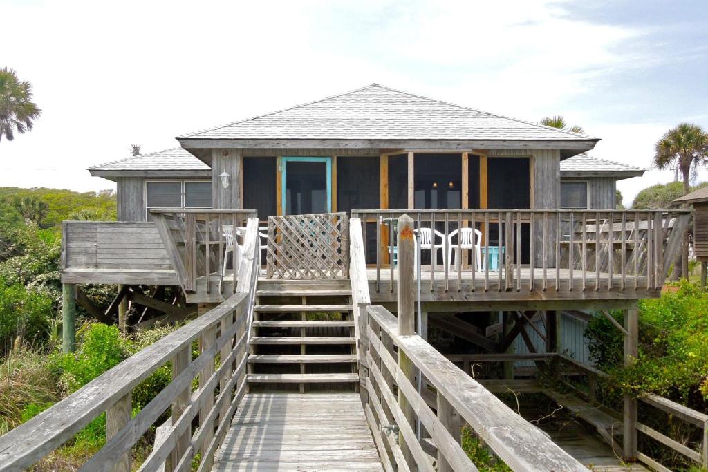 a house on a pier with stairs leading to it at Sho-rest in Folly Beach
