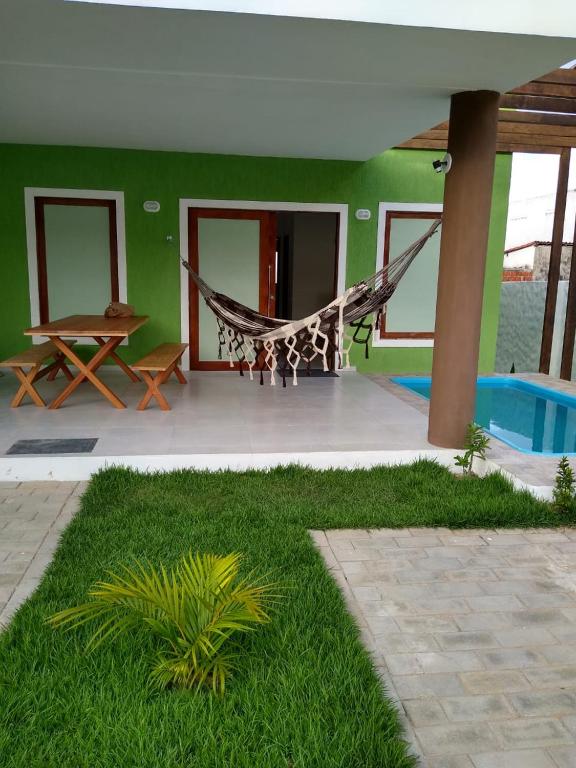 a hammock in the middle of a house at GREEN HOUSE in Pipa