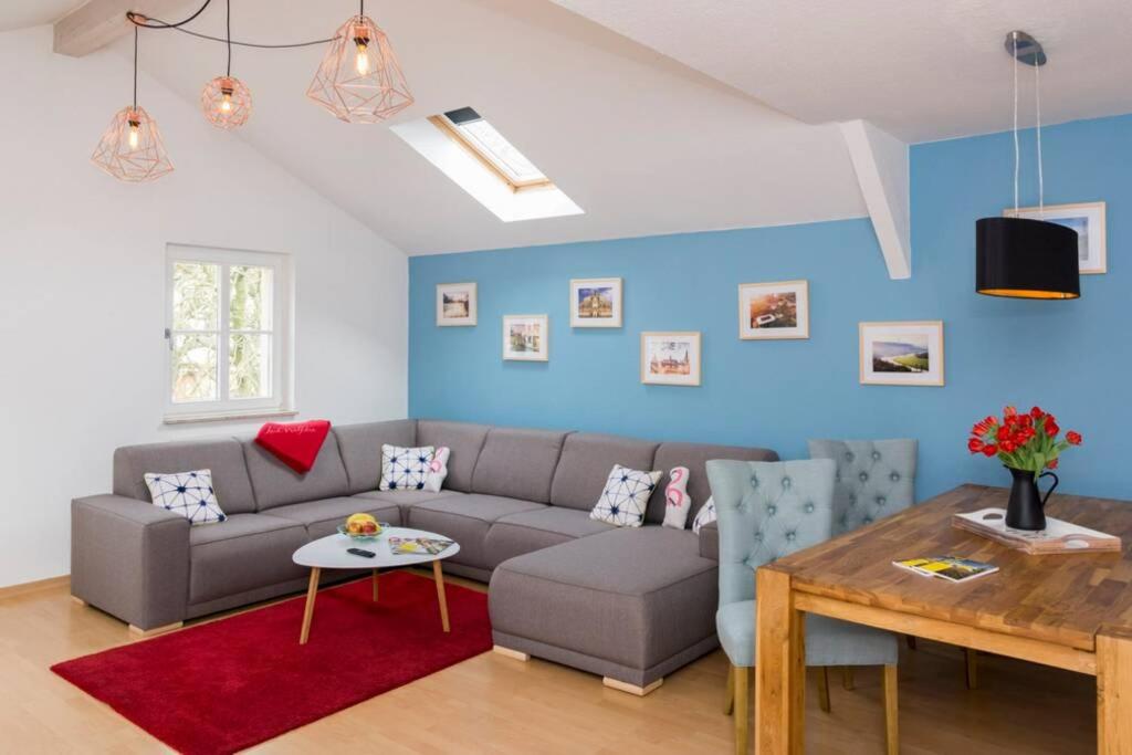 a living room with a couch and a table at Rooftop - das Apartment mit Dachterrasse in Dresden