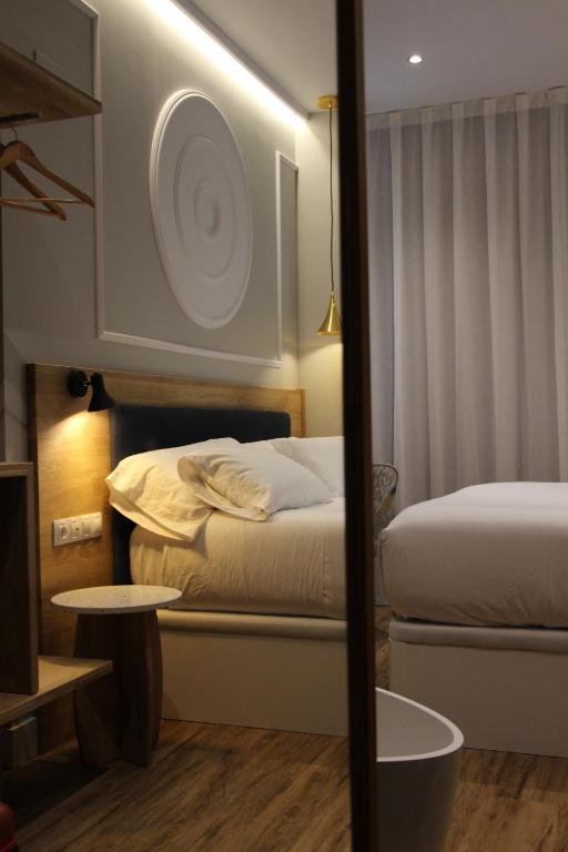 Postel nebo postele na pokoji v ubytování Habital Suites