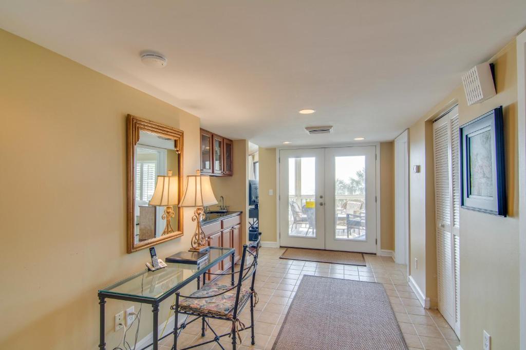 a living room with a glass table and chairs at Tidewater H-202 in Isle of Palms