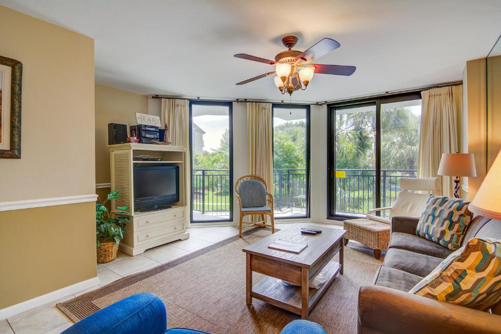 a living room with a couch and a ceiling fan at Shipwatch C-116 in Isle of Palms