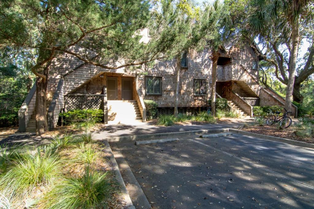 a brick house with a driveway and trees at Mariner's Watch 4288 in Kiawah Island