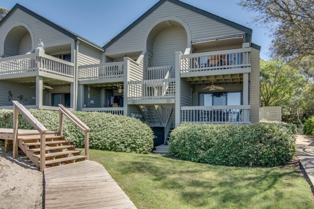 a house with a staircase and a balcony at Pelican Watch 1350 in Seabrook Island