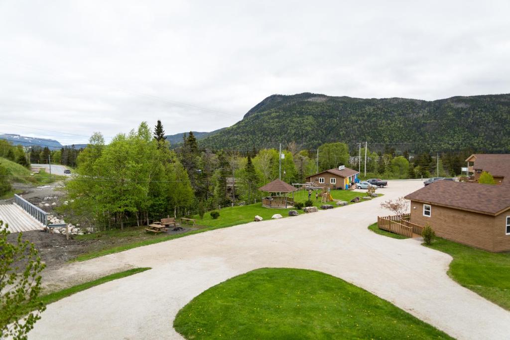 an aerial view of a driveway with mountains in the background at Middle Brook Cottages & Chalets in Glenburnie