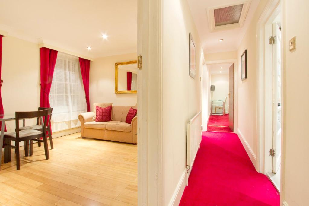 a hallway with a red carpet in a living room at Sapphire in London