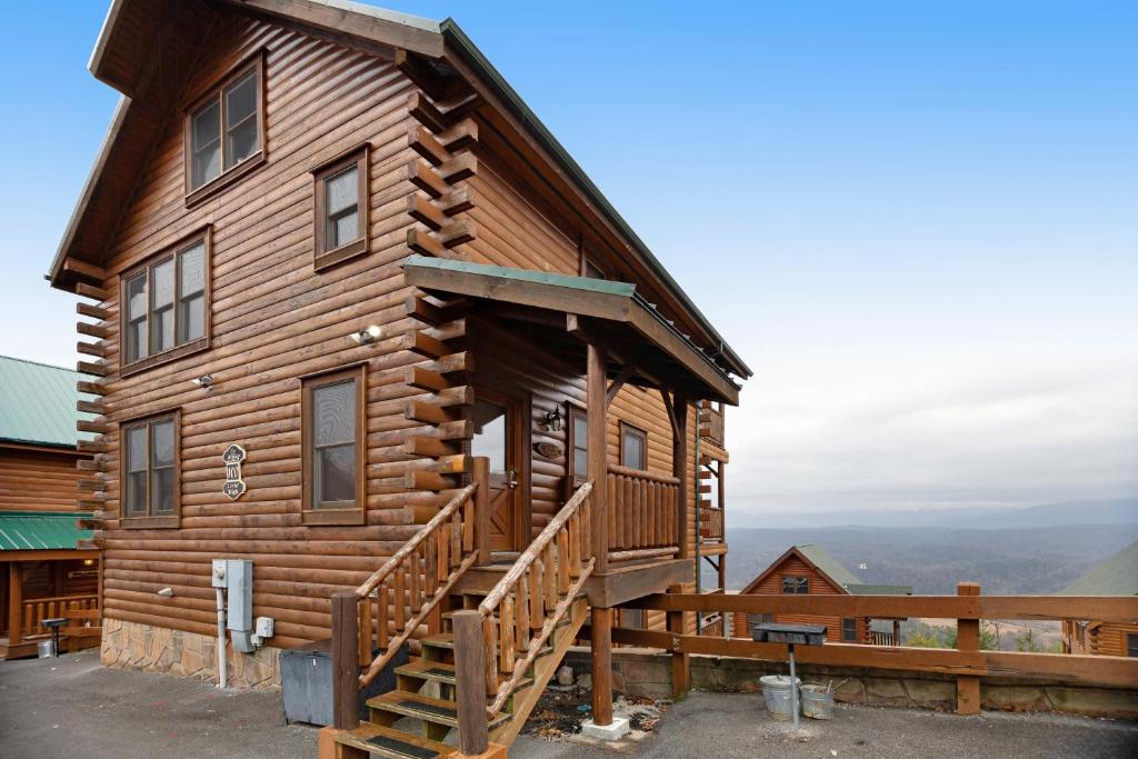 a log cabin with a deck and a balcony at Livin High in Sevierville