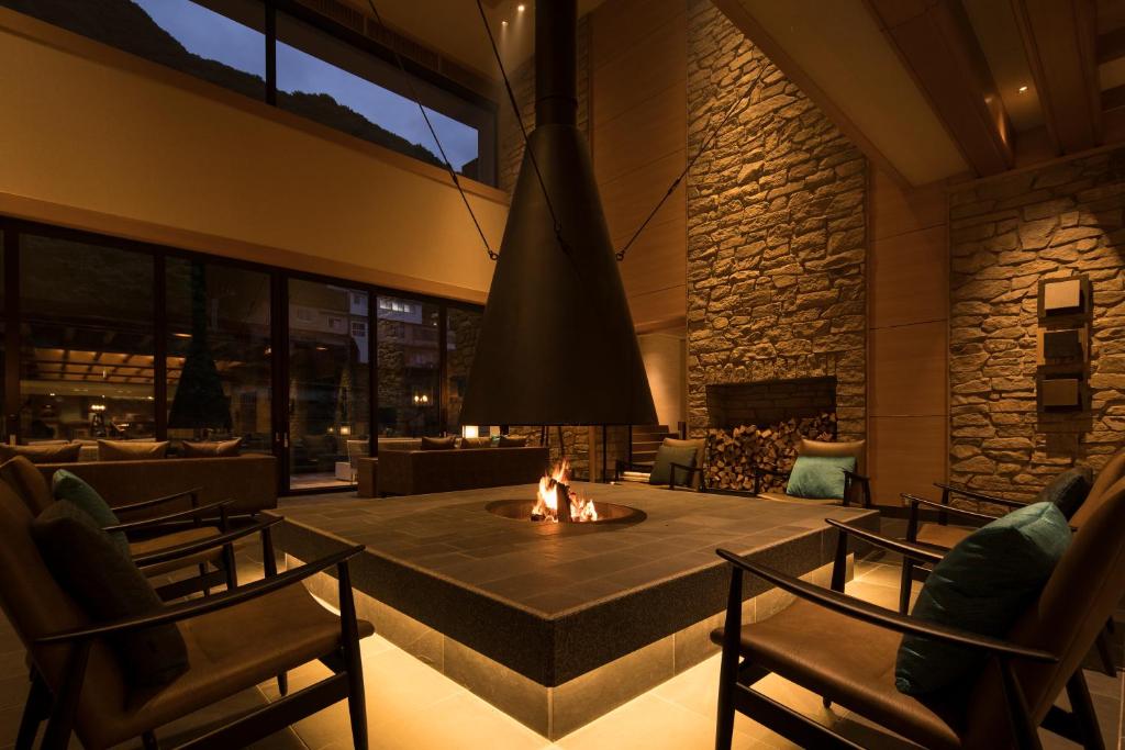 a living room with a fire pit in the middle at Minakami Hotel Juraku in Minakami