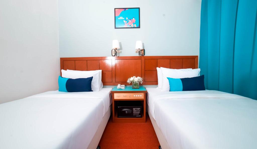 Postel nebo postele na pokoji v ubytování JO Hotel Johor Bahru