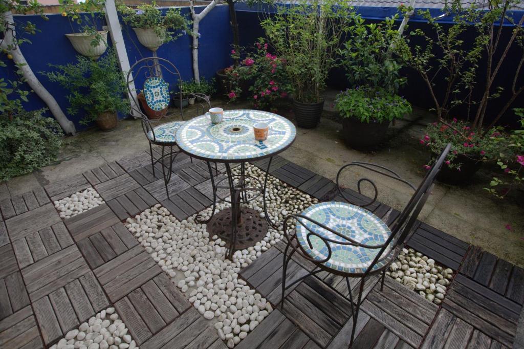a patio with a table and chairs and plants at Dot Minsu in Wujie