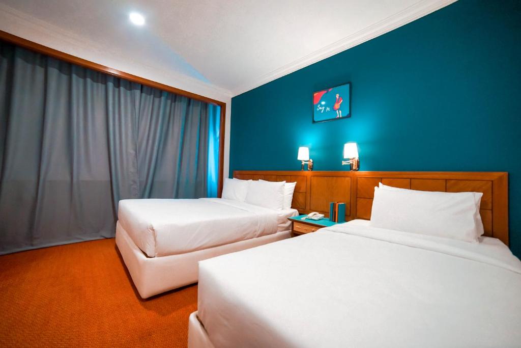 Postel nebo postele na pokoji v ubytování JO Hotel Johor Bahru