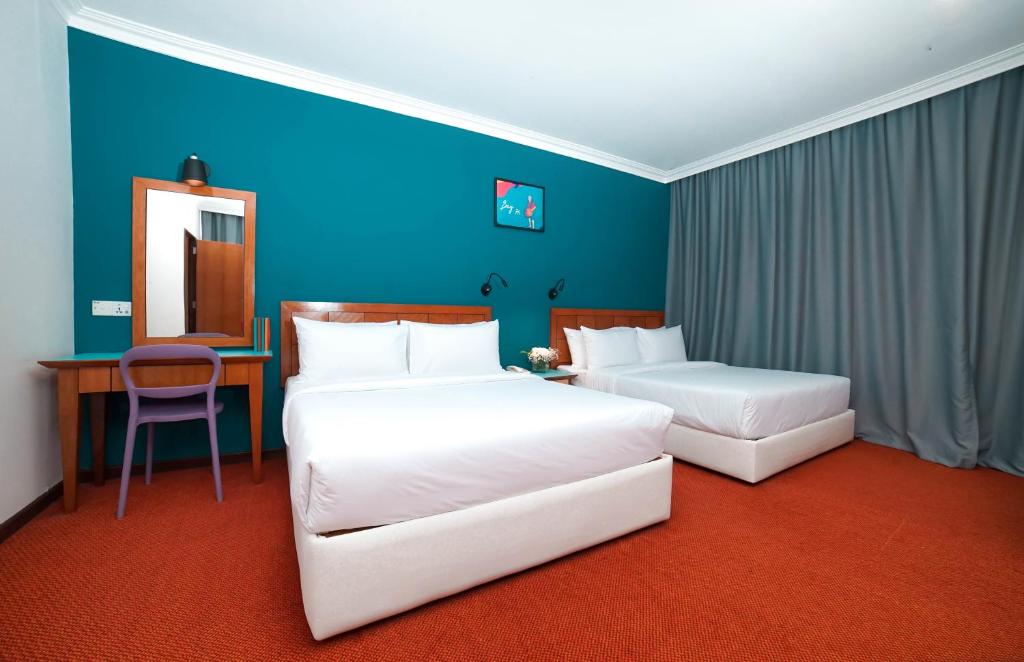 Postel nebo postele na pokoji v ubytování JO Hotel Johor Bahru