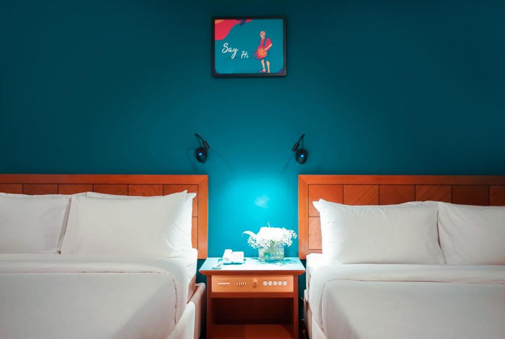 Postel nebo postele na pokoji v ubytování JO Hotel Johor Bahru