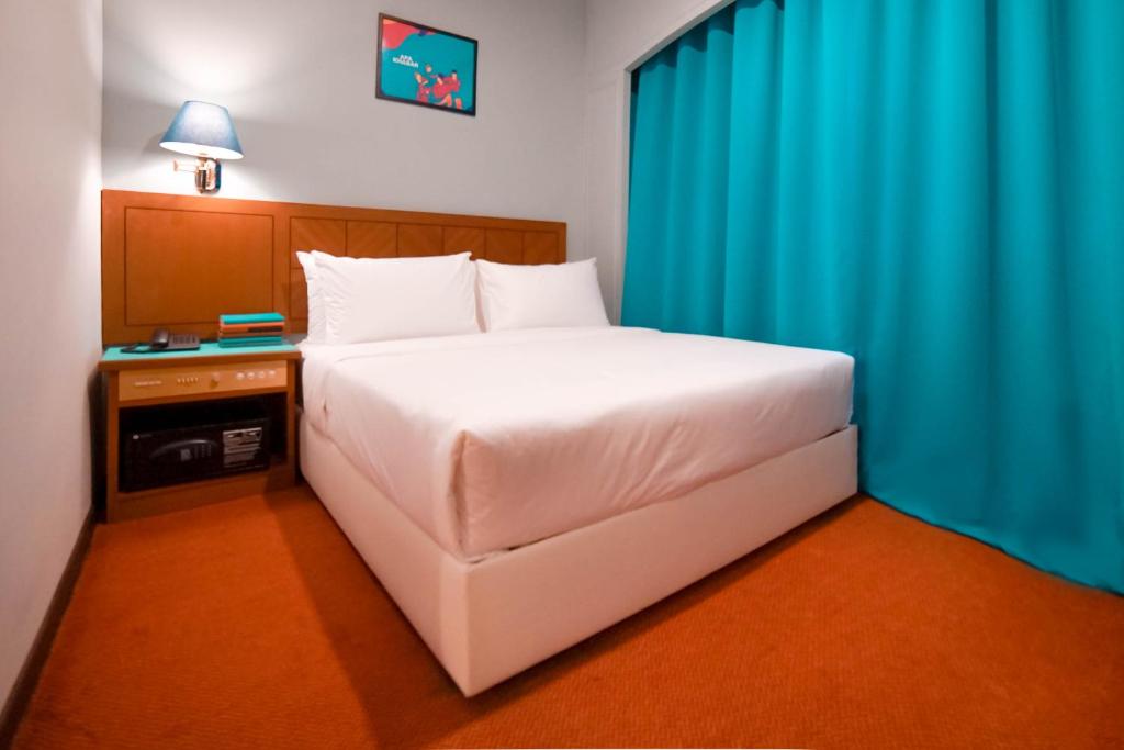 Postel nebo postele na pokoji v ubytování JO Hotel Johor Bahru