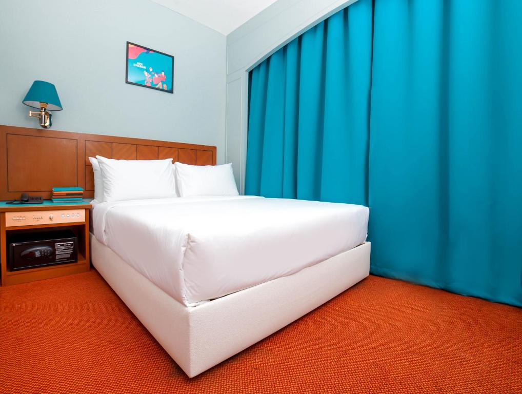 Postel nebo postele na pokoji v ubytování JO Hotel Johor Bahru