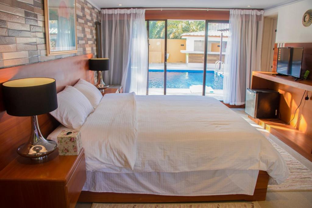 a bedroom with a large bed and a pool at The Inn Nizwa in Nizwa