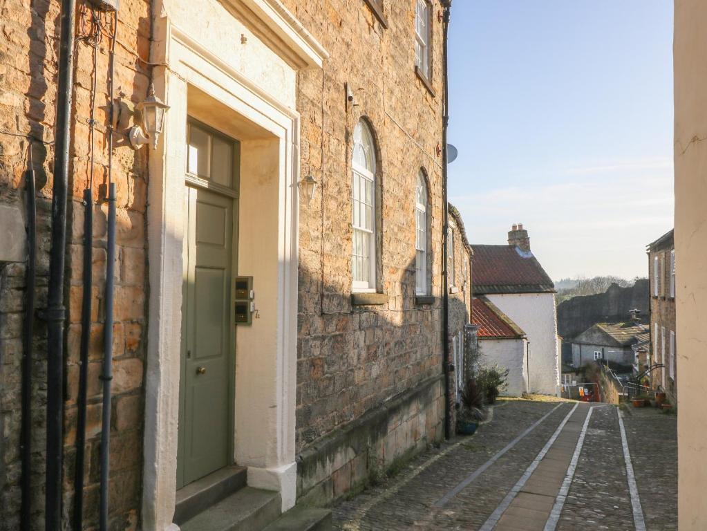 an alley in an old building with a green door at Swale View in Richmond