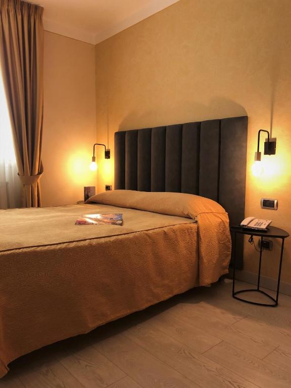 Postel nebo postele na pokoji v ubytování Hotel Tirrenia