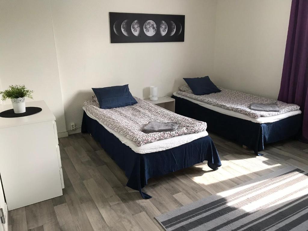 イェヴレにあるGävle Bed & Breakfastの紫色のカーテンが備わる客室のベッド2台