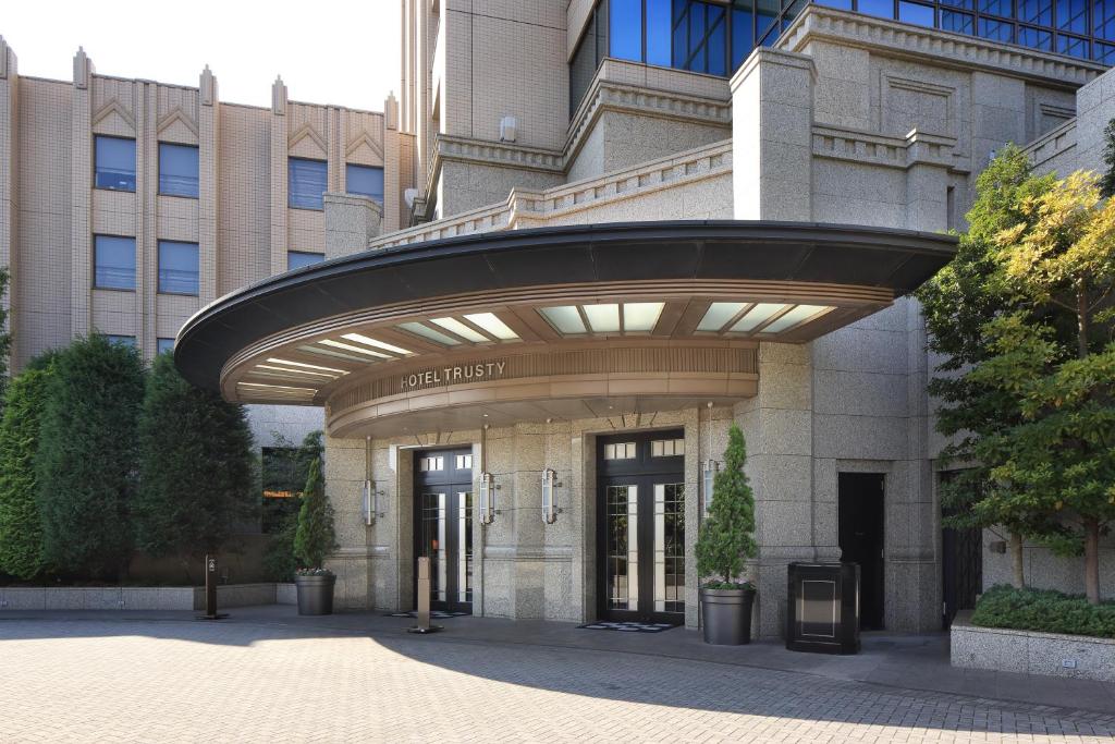 a building with an archway in front of it at Hotel Trusty Tokyo Bayside in Tokyo