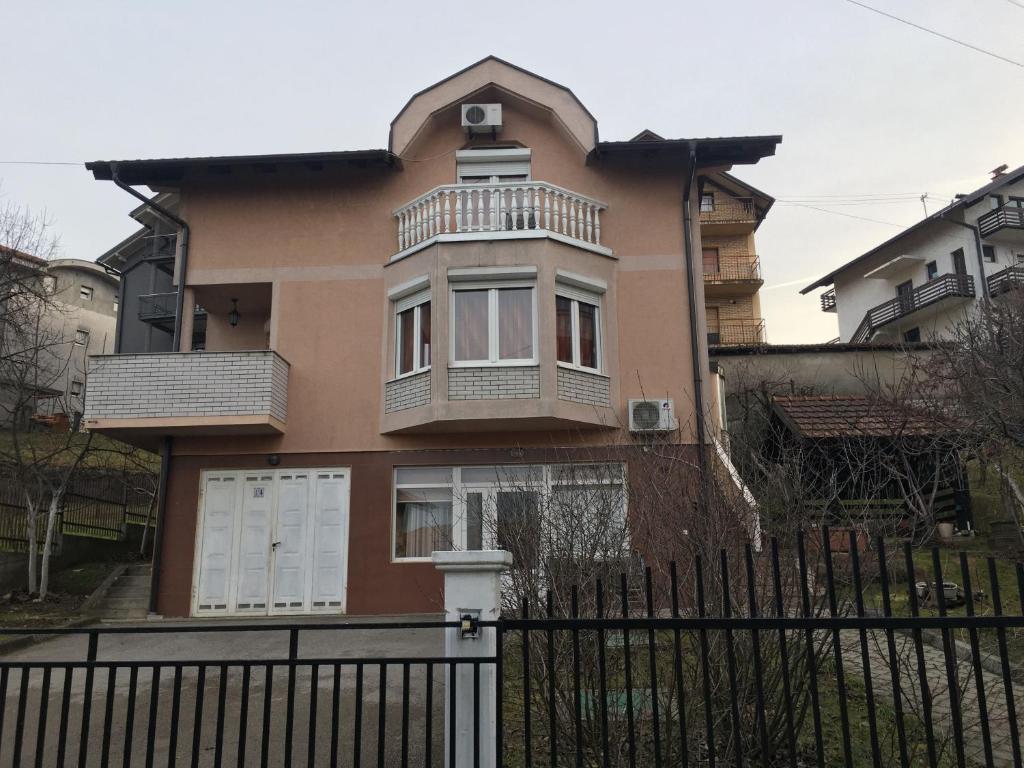a house with a fence in front of it at Apartment Mirjana in Banja Luka