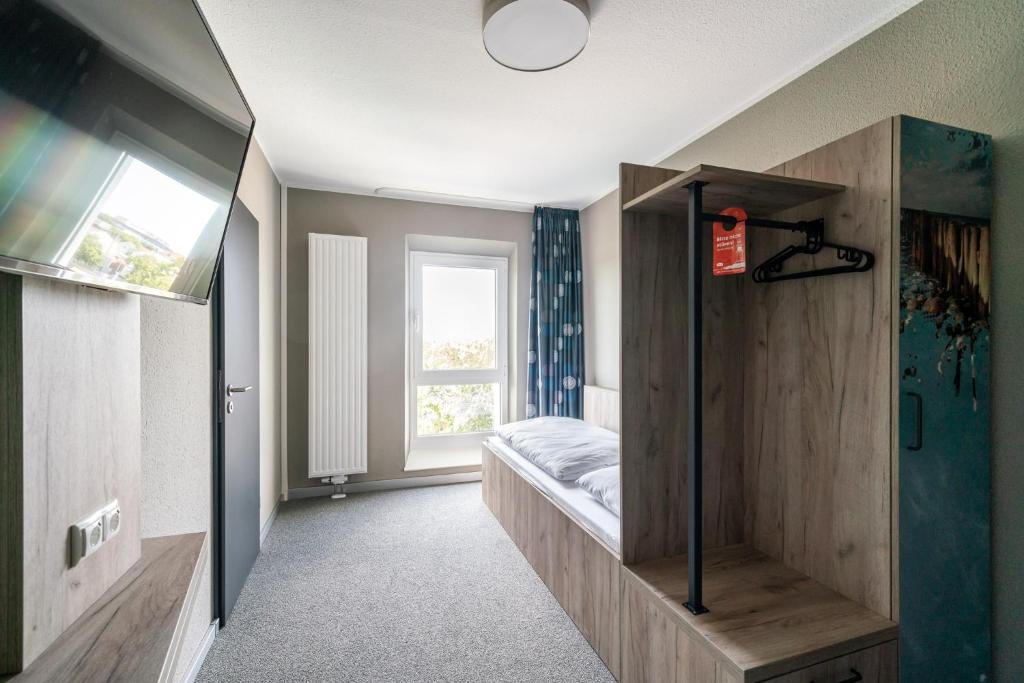 Postel nebo postele na pokoji v ubytování WIROtel Warnemünde