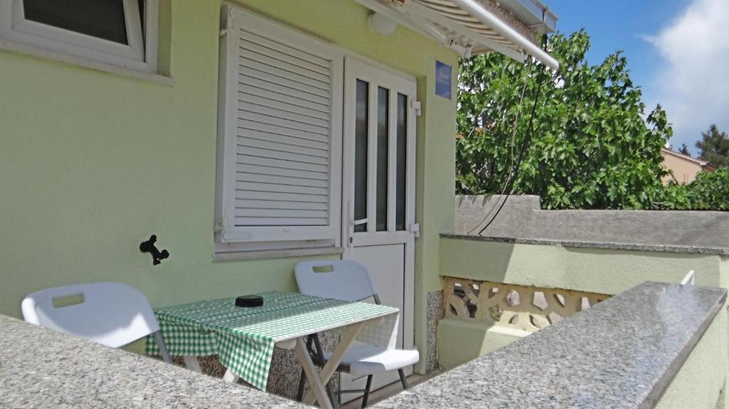 a table and chairs on the balcony of a house at STUDIO MIMI CENTER OF TOWN KRK CROATIA in Krk