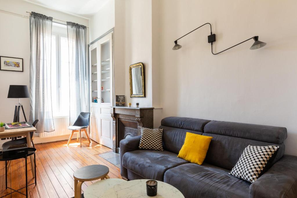 - un salon avec un canapé et une table dans l'établissement DIFY Masséna - Brotteaux, à Lyon