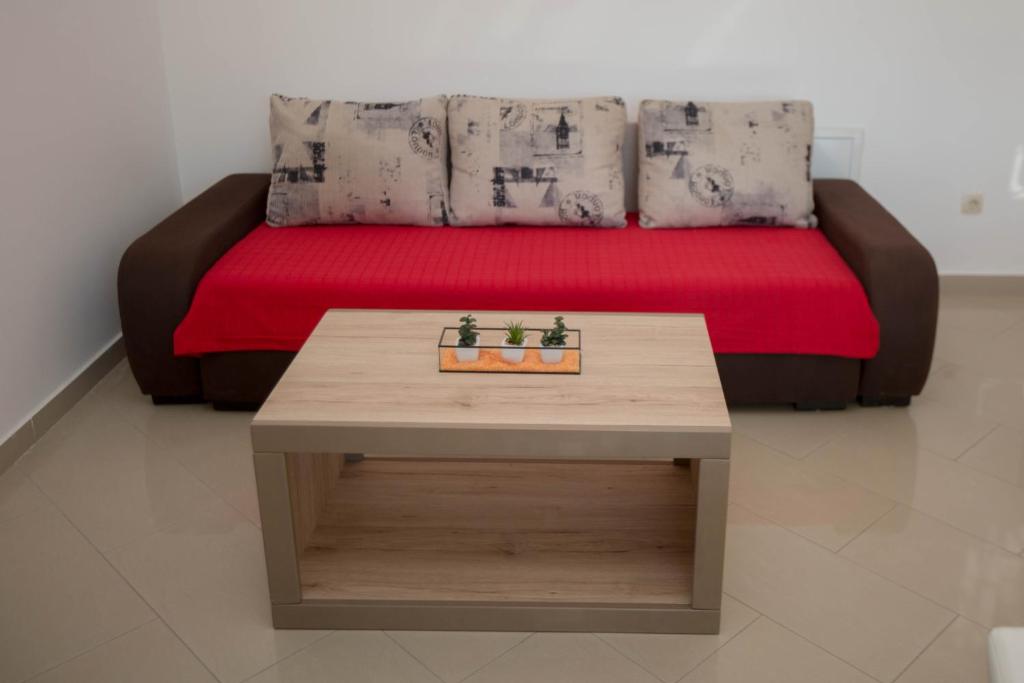 a room with a bed with a table and a bench at Guest House Kukuljica 2 in Zaton