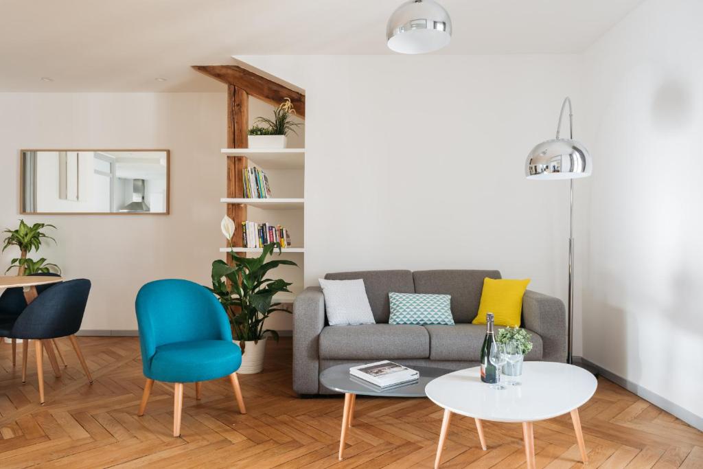 a living room with a couch and chairs at DIFY Cosy - Centre Ville in Lyon