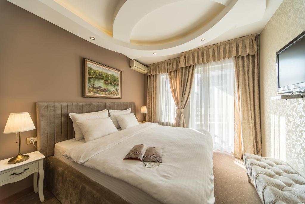 Postel nebo postele na pokoji v ubytování Garni Hotel President de Luxe