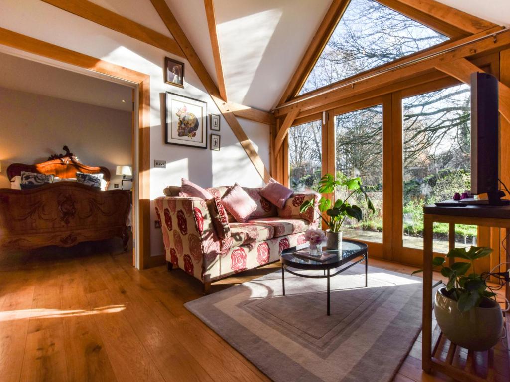 a living room with a couch and a table at Sycamore in Bibury