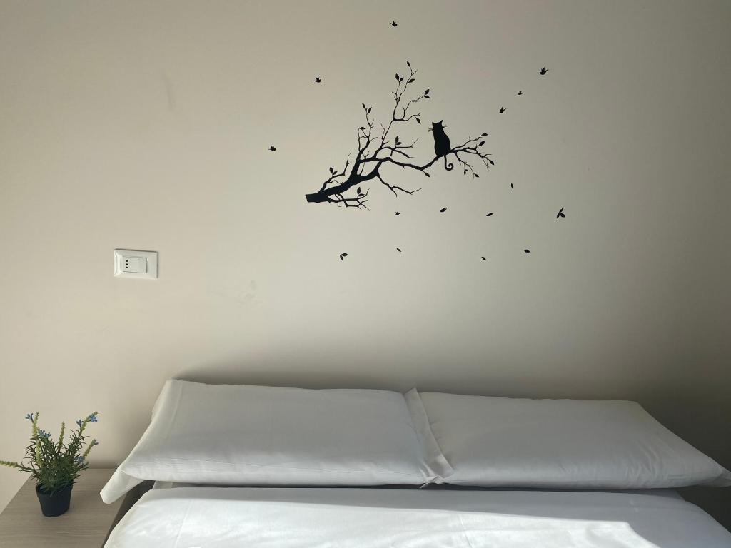 
a bed with a picture of a bird on it at Hightown Hostel in Milan

