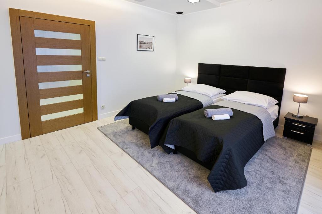 Postel nebo postele na pokoji v ubytování Prestige Apartamenty VINCI Centrum