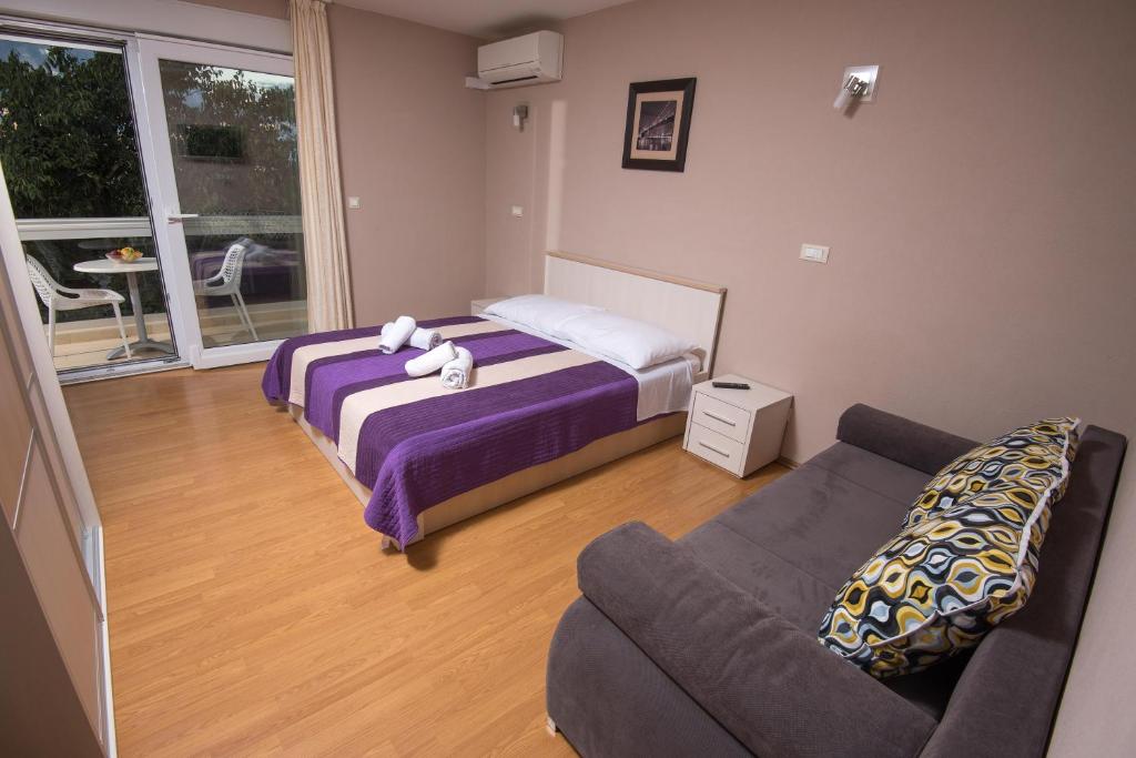 Postel nebo postele na pokoji v ubytování Apartments Vlasic