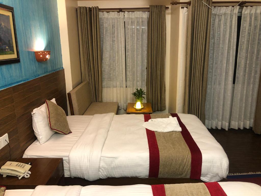 Letto o letti in una camera di Hotel Guru