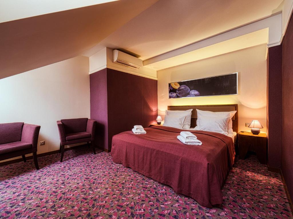 A bed or beds in a room at Penzión Gurmen