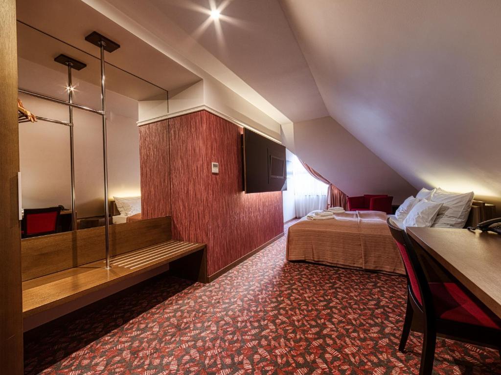 A bed or beds in a room at Penzión Gurmen