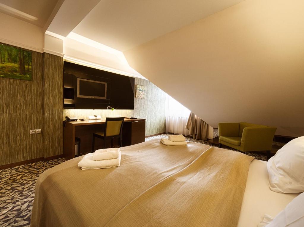 A bed or beds in a room at Penzión Gurmen