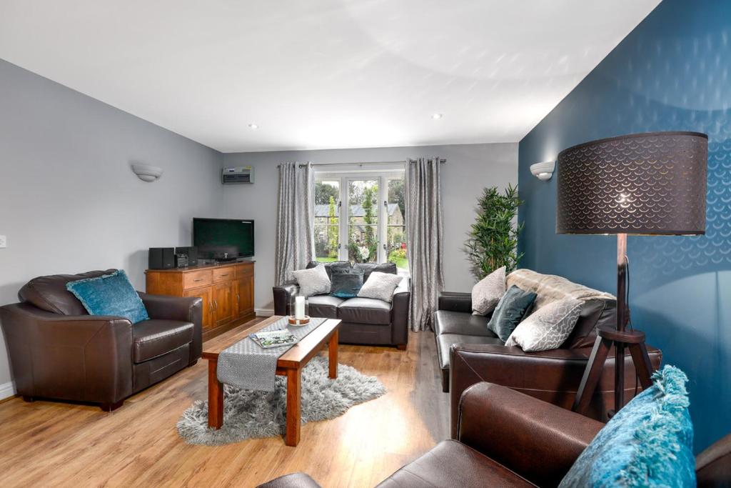 a living room with a couch and a table at Hassop Cottage - Darwin Lake Holiday Village in Matlock