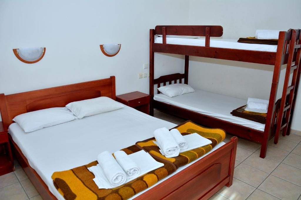 a room with two bunk beds with towels on them at Glaros in Paralia Katerinis