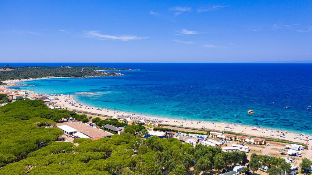 an aerial view of a beach with people in the water at Camping Village Baia Blu La Tortuga in Aglientu