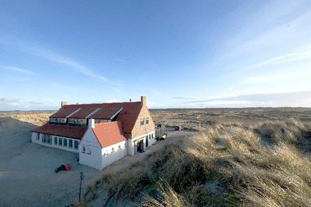 una casa grande en medio de un campo en Strandhotel Terschelling B&B en Formerum