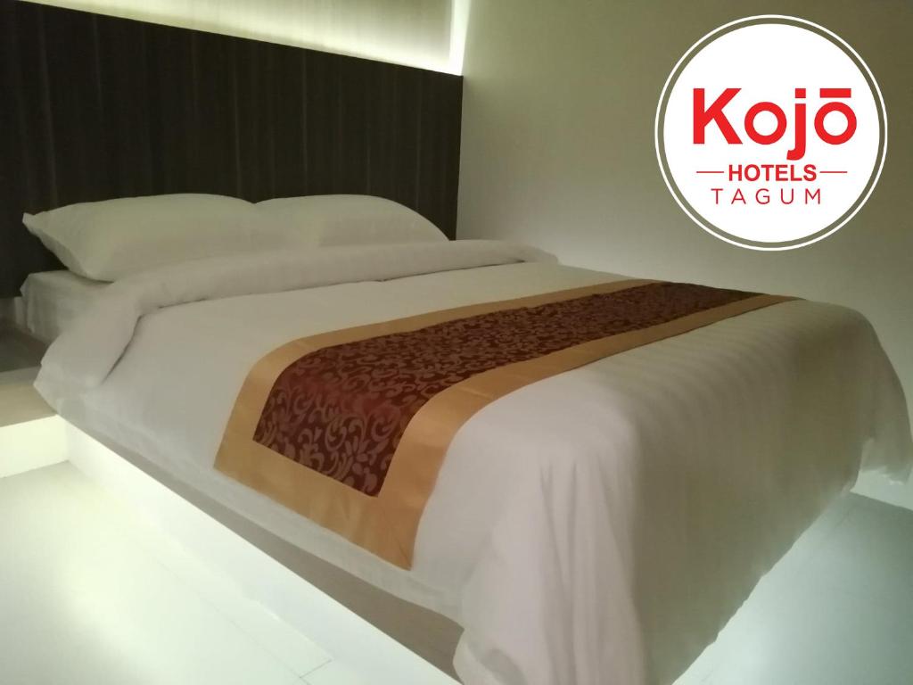 Postel nebo postele na pokoji v ubytování Kojõ Hotel Tagum