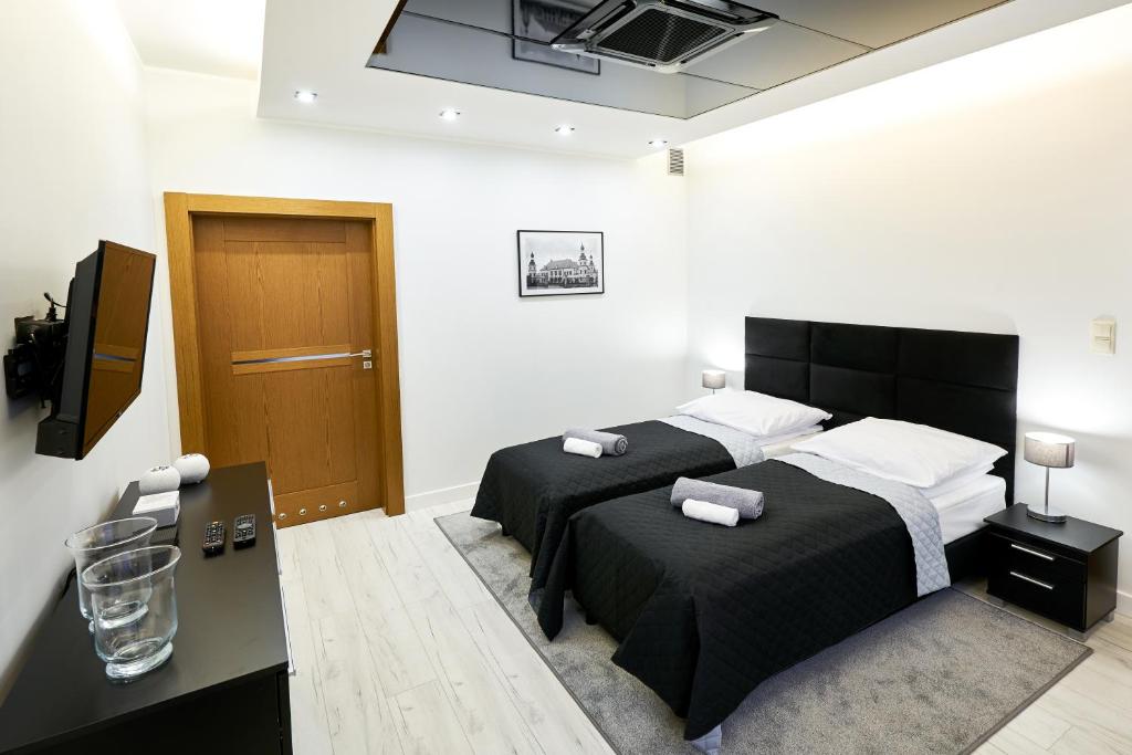 Postel nebo postele na pokoji v ubytování Prestige Apartamenty VINCI Centrum
