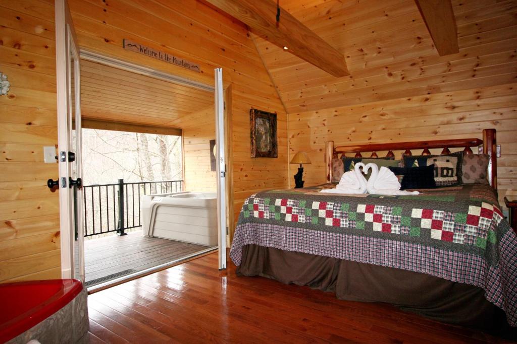 a bedroom with a bed in a wooden cabin at Lovin' Inn in Gatlinburg